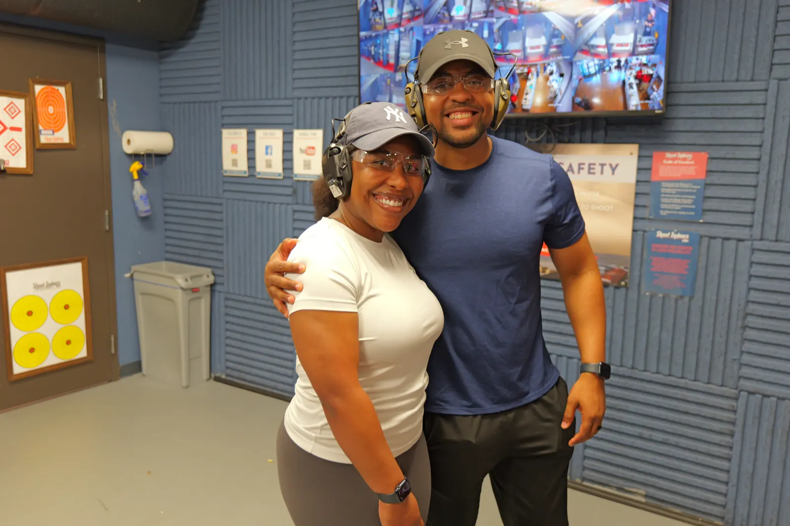 Two shooters smiling with eye and ear protection at Shoot Indoors KOP