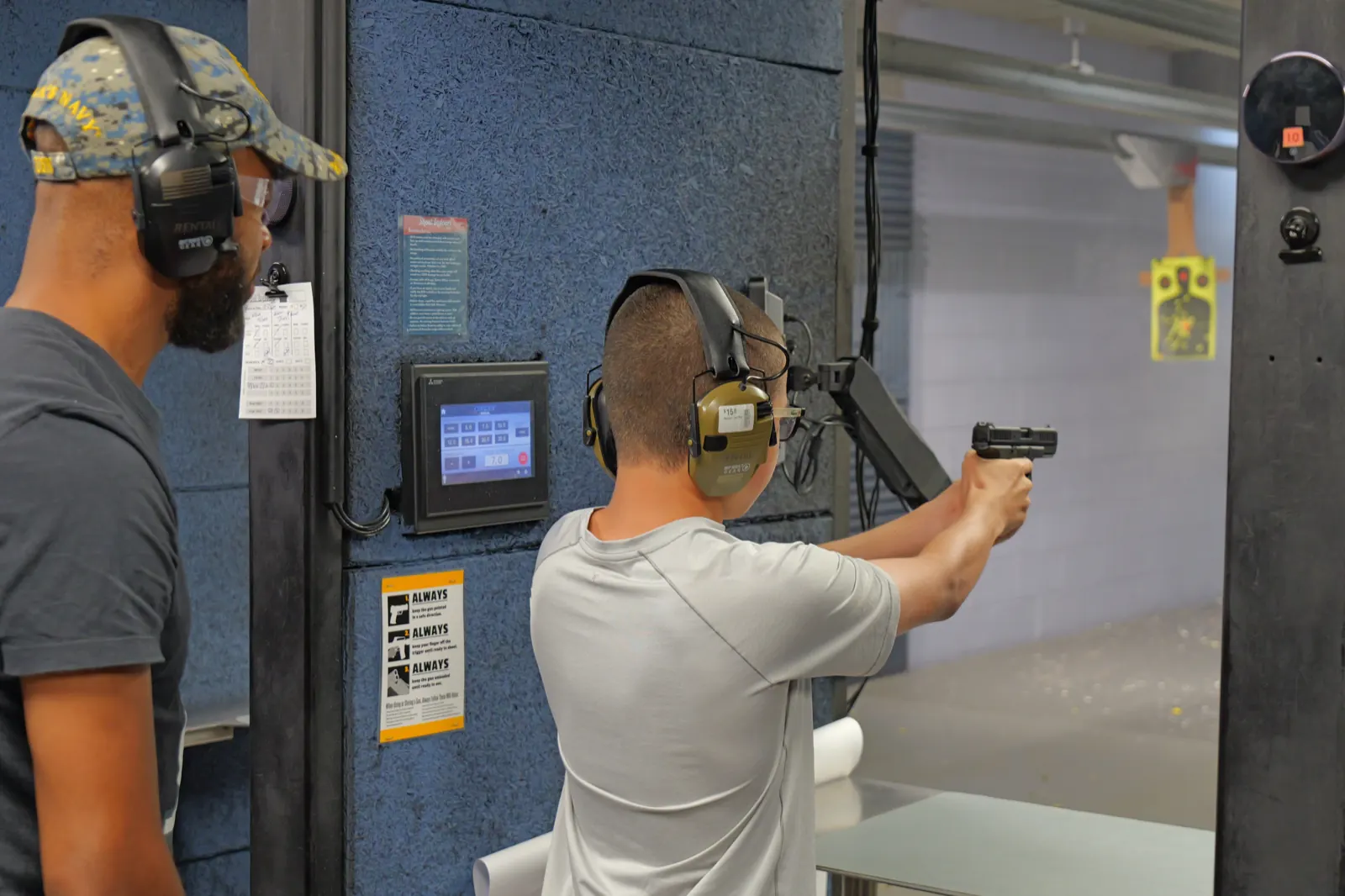 Shooter practicing on a lane with instructor supervision